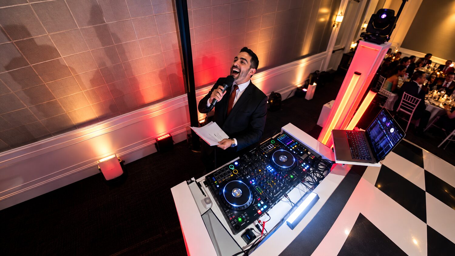 DJ Fidel on the mic hyping up the crowd