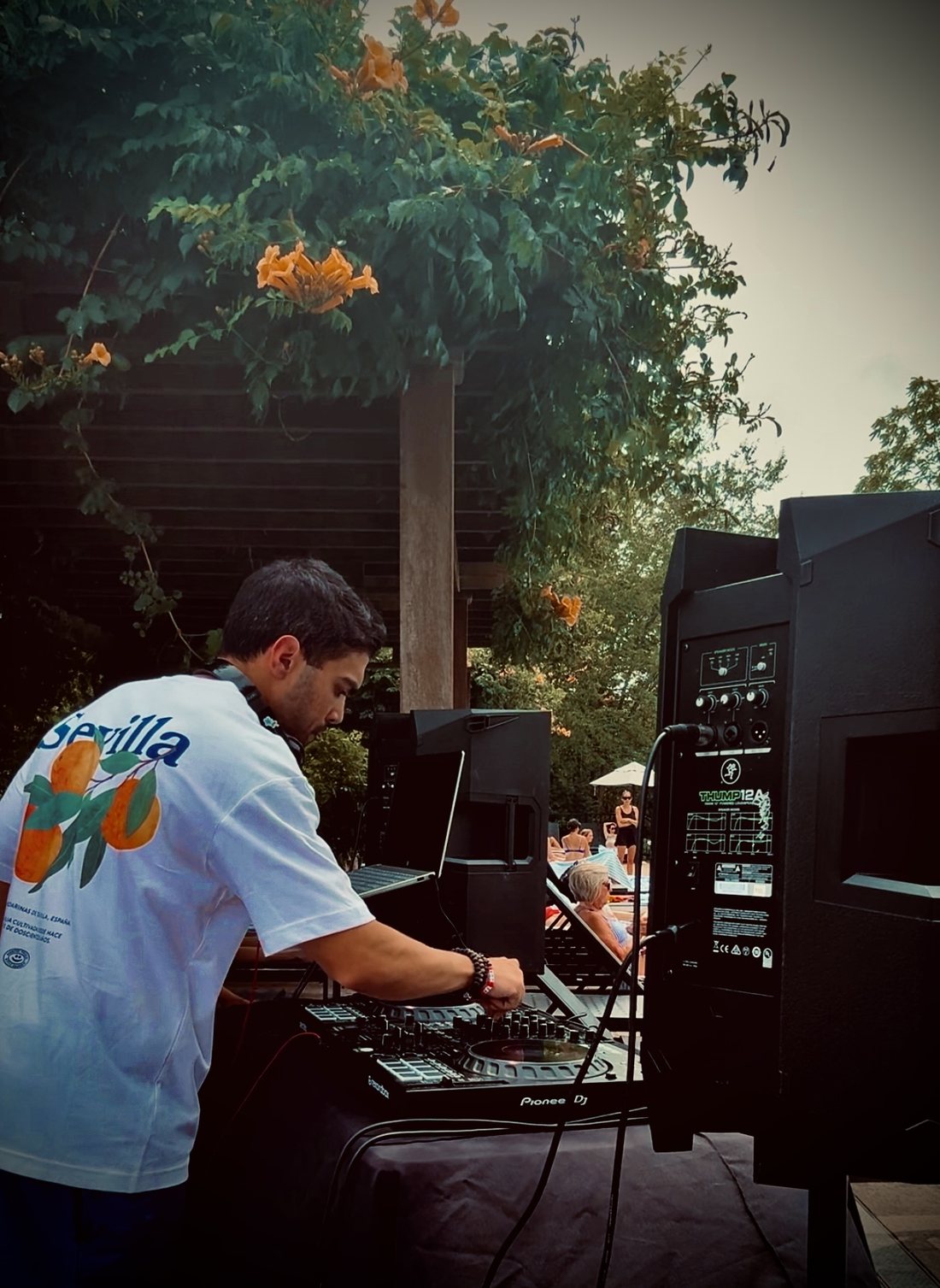 DJ Fidel spinning at an outdoor poolside private party