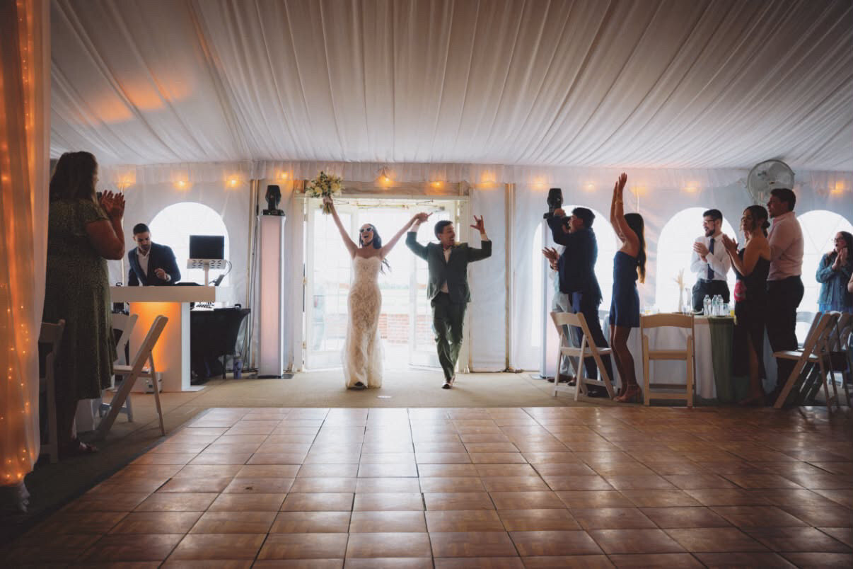 Jersey and Nathan's grand entrance into the tented reception at Northfork Farm
